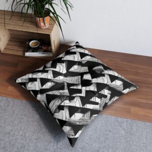 Tufted floor pillow with a pattern of woven monochrome parallelograms