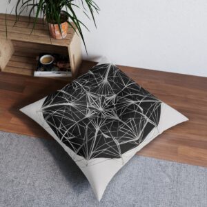 Black and white tufted floor pillow with intricate geometric web design