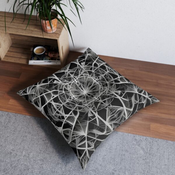 Tufted floor pillow with black and white intricate geometric web design