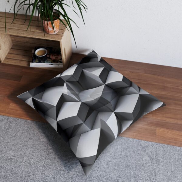 Geometric depth tufted floor pillow with three-dimensional gray cube pattern