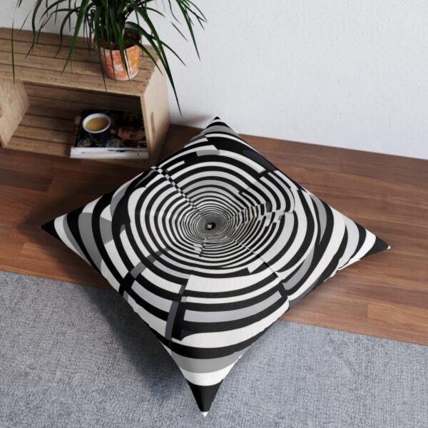 Hypnotic swirl tufted floor pillow with monochrome concentric circles