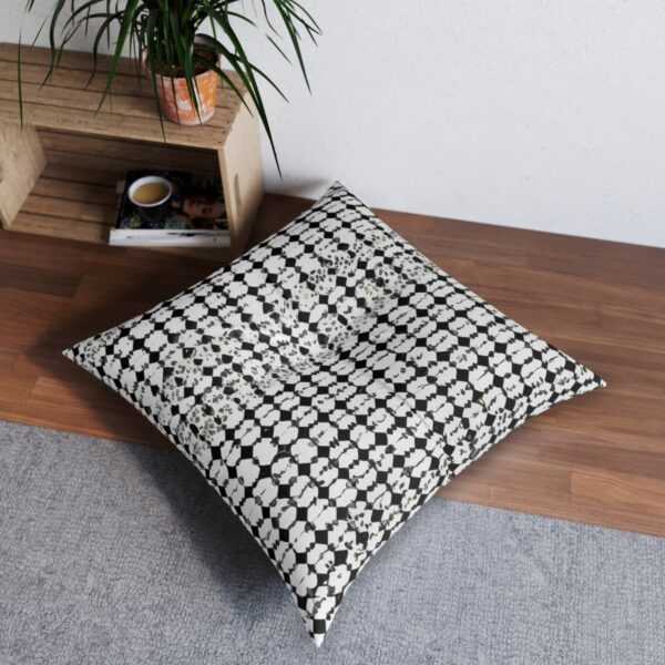 Mosaic grid tufted floor pillow with black and white tessellated pattern