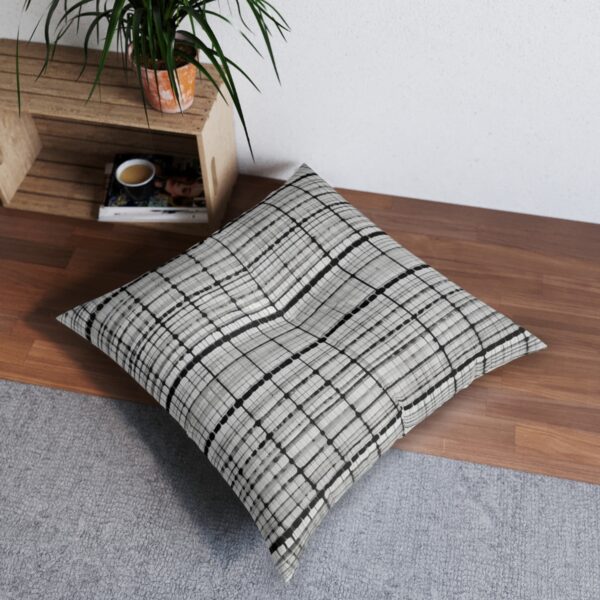 Checkered illusion tufted floor pillow with black squares on white