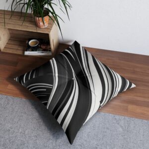 Bold black and white tufted floor pillow with dynamic angular waves