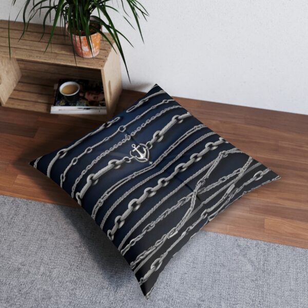 Deep oceanic tones tufted floor pillow with network of anchor chains on dark blue stripes