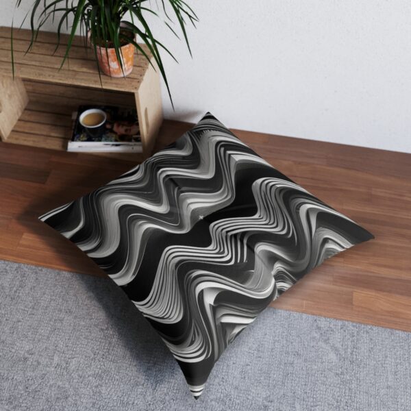 Dynamic swirling black and white tufted floor pillow