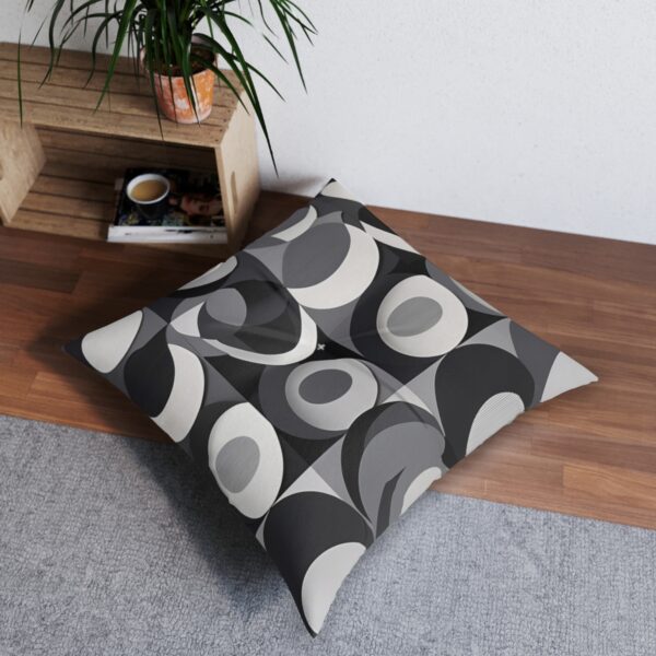 Gray tufted floor pillow with overlapping circles pattern