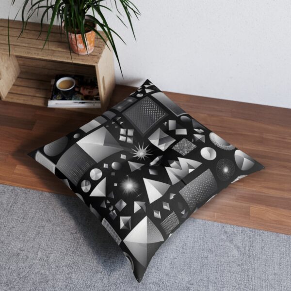 Tufted floor pillow with striking array of geometric shapes in grayscale