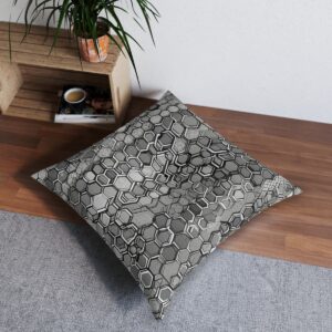 Tufted floor pillow with hexagonal pattern in shades of gray