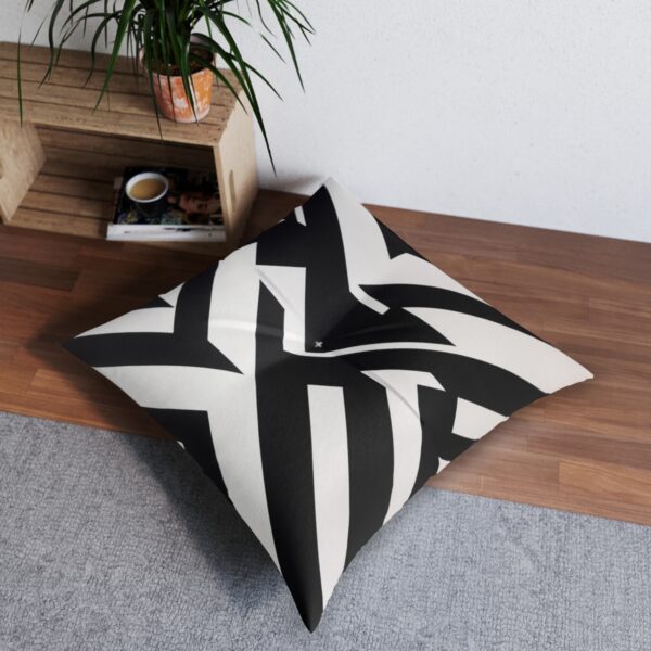 Tufted floor pillow with bold abstract black and white pattern