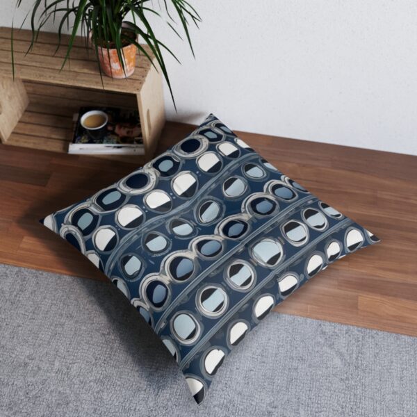 Tufted floor pillow with array of portholes on a navy striped canvas