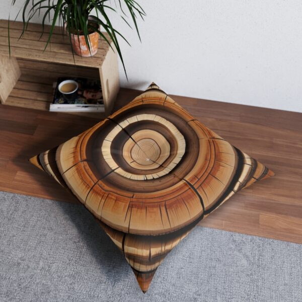 Richly textured tree ring design tufted floor pillow in amber and espresso shades