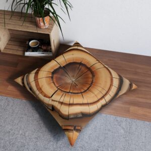 Spiral tree ring design tufted floor pillow in golden brown with black accents