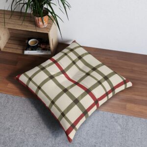 Square tufted floor pillow with apple red and moss green plaid on cream background