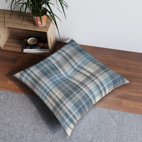 Plaid-patterned floor pillow in shades of sky blue and soft gray