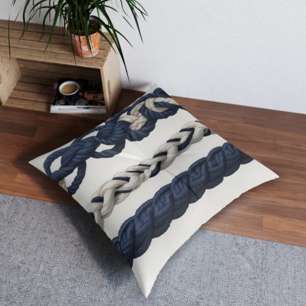 Tufted floor pillow with intricate sailor's knots and classic navy stripes