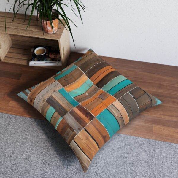 Vibrant teal accented wooden plank tufted floor pillow in a contemporary room