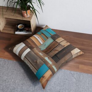 Reclaimed wood plank tufted floor pillow with teal accents in a rustic home