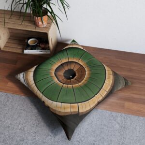 Square tufted floor pillow with vibrant green tree ring design