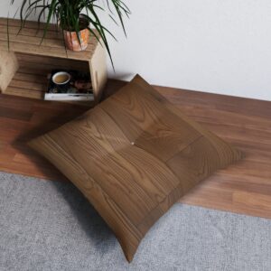 Square tufted floor pillow with wood grain design on a hardwood floor