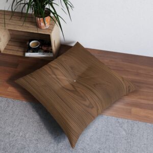 Square tufted floor pillow with wood grain texture design on hardwood floor.