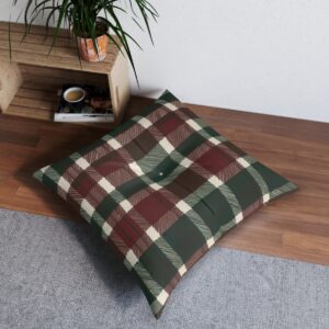 Square tufted floor pillow with green, red, and brown plaid pattern on wooden floor