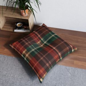 Square tufted floor pillow with traditional plaid pattern in reds greens and browns