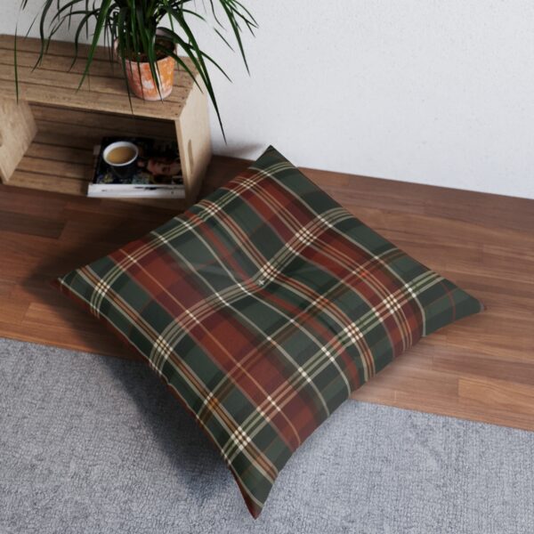 Square tufted floor pillow with red and green plaid pattern