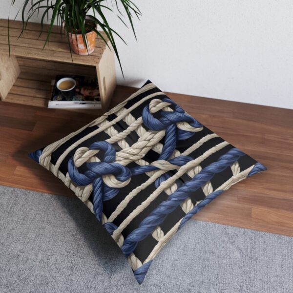 Beautifully crafted tufted floor pillow with interweaving knotted ropes and navy stripes