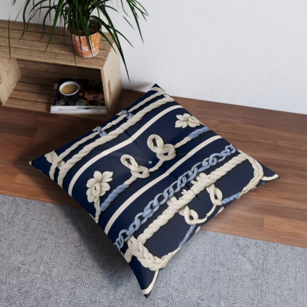 Tufted floor pillow with a variety of knotted ropes over navy stripes