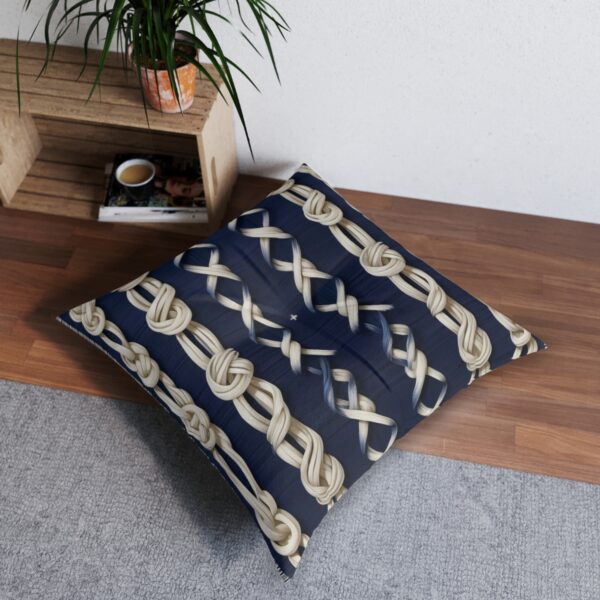 Tufted floor pillow with a medley of knotted ropes against navy stripes