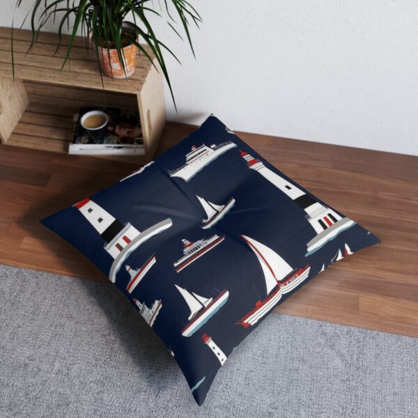 Tufted floor pillow with lighthouses and sailing ships framed by navy stripes