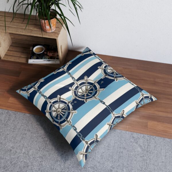 Nautical-themed tufted floor pillow with ship wheels on stripes