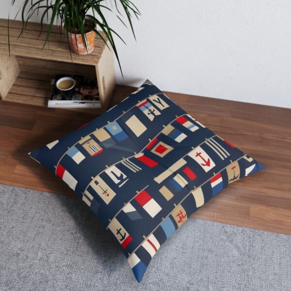 Nautical signal flags on navy blue and cream striped tufted floor pillow