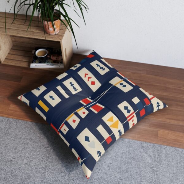 Navy blue and cream striped tufted floor pillow with signal flags