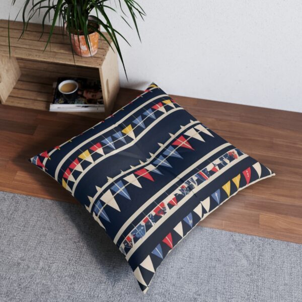 Festive nautical signal flags tufted floor pillow on grey rug