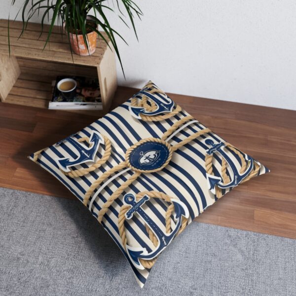 Striped tufted floor pillow with bold anchors and compass motifs