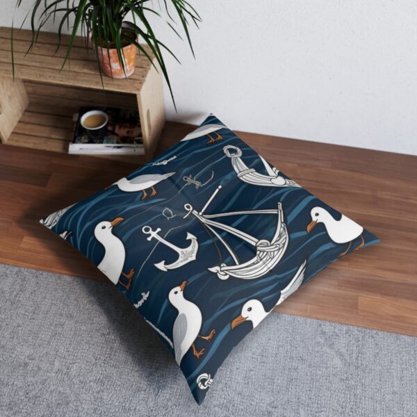 Dark blue sea-inspired tufted floor pillow with charming seagulls and nautical elements