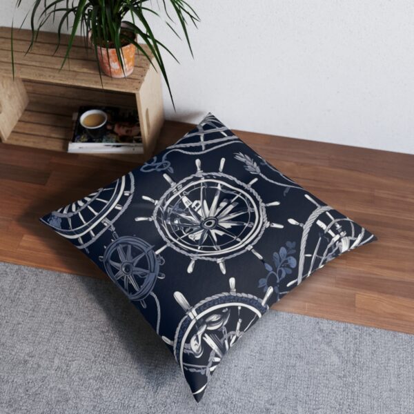 Dark background tufted floor pillow with ship's wheels design