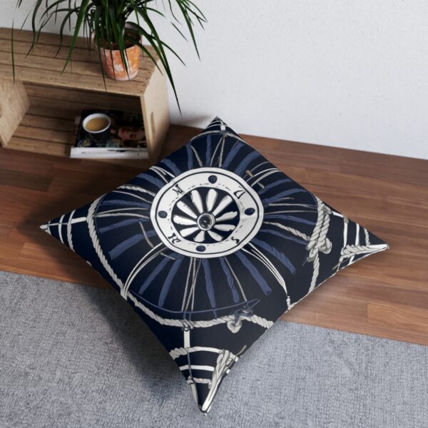 Navy tufted floor pillow with detailed ship's wheel and knotted rope design