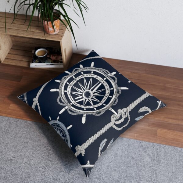 Navy tufted floor pillow with ship's wheel and knotted rope design