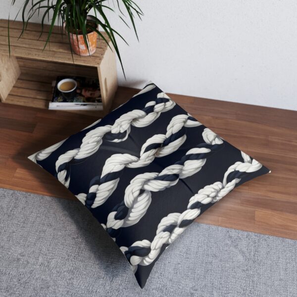 Navy tufted floor pillow with cream rope design