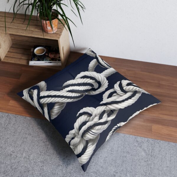 Navy tufted floor pillow with white twisted rope design