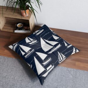 Navy floor pillow adorned with crisp white sailboats