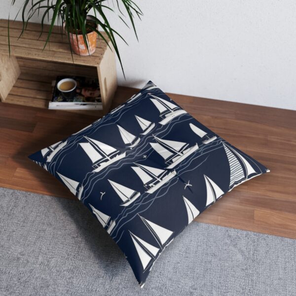 Navy floor pillow with a regatta of white sailboats design