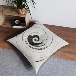 White tufted floor pillow with graceful black spiral