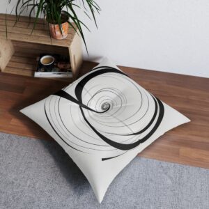 White tufted floor pillow with a single black line spiral