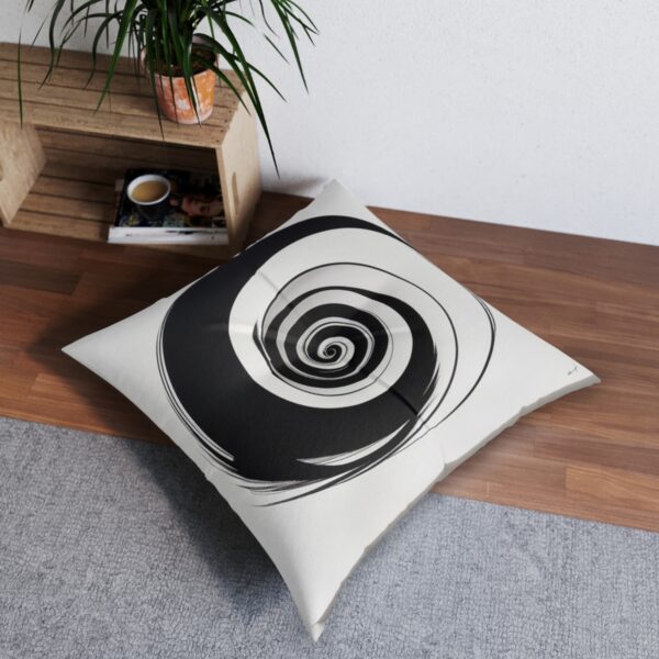 White tufted floor pillow with black spiral design