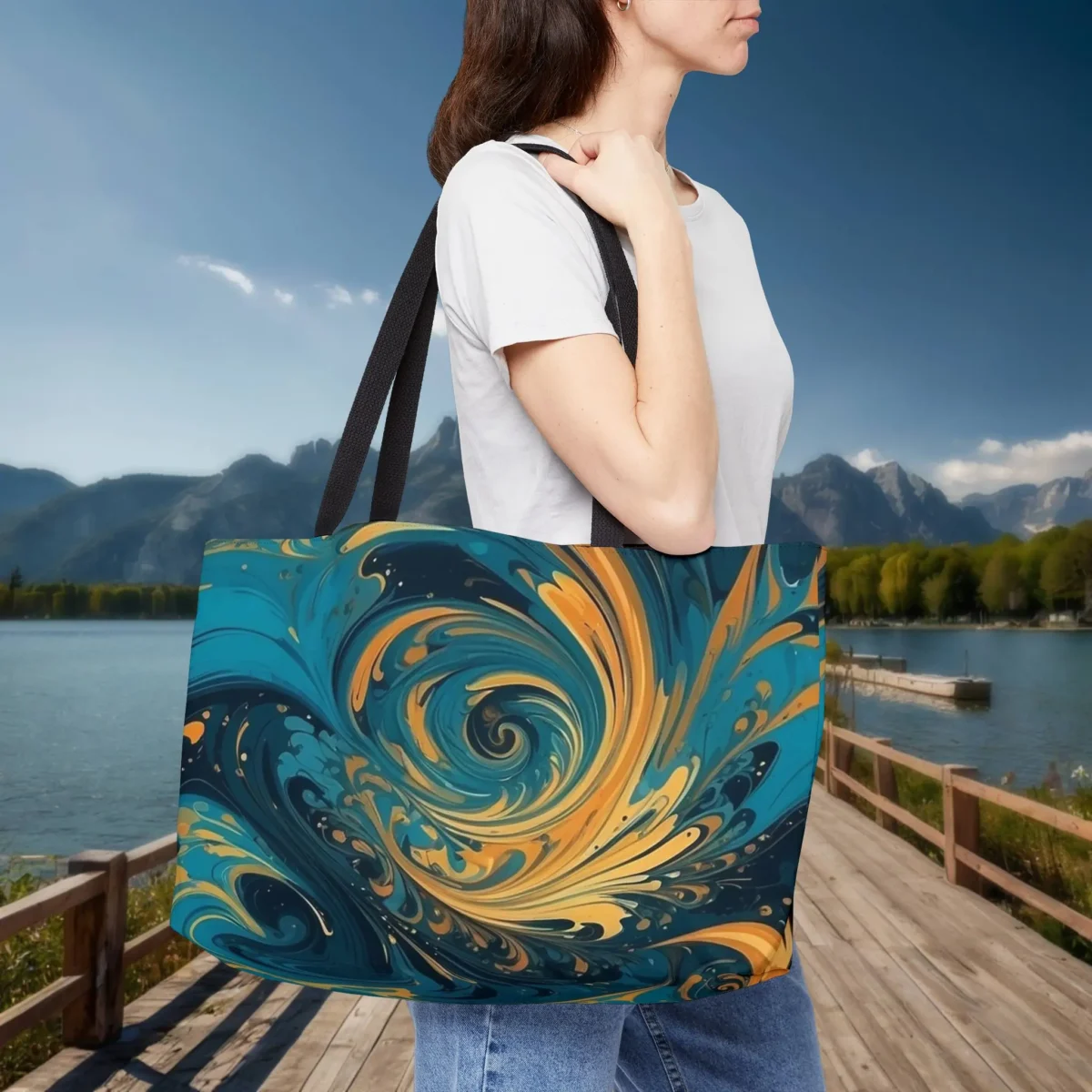 Woman wearing a weekender tote bag with abstract blue and yellow swirl pattern design