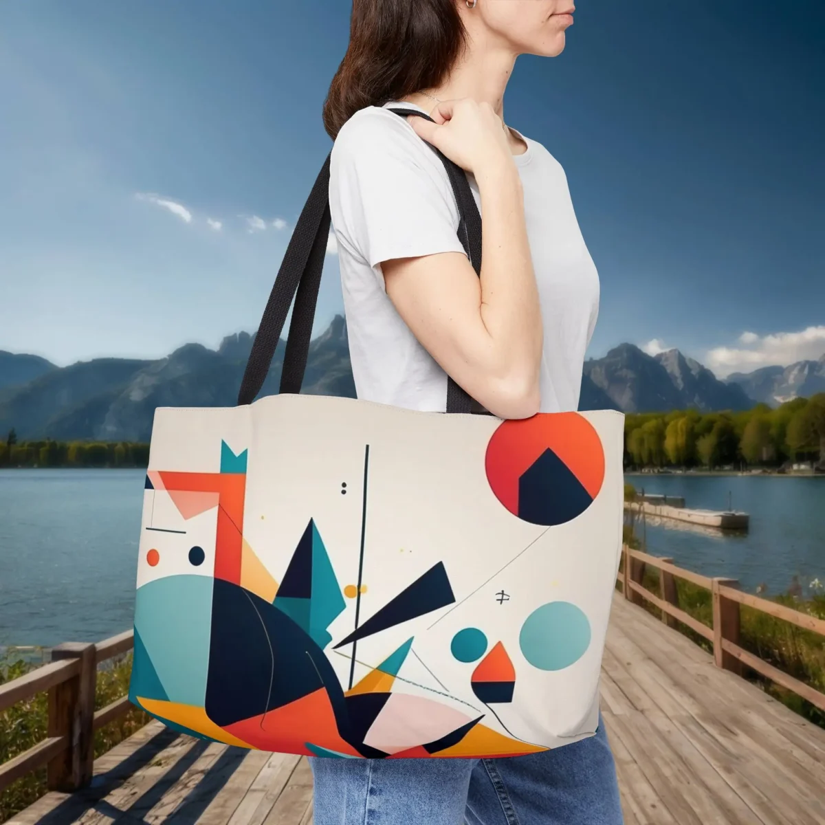 Woman wearing a weekender tote bag with colorful abstract geometric design
